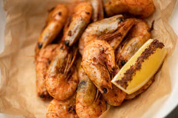 Fried shrimp with spices and lemon. Healthy eating. Seafood concept. Top view. Close up shot. Soft focus.