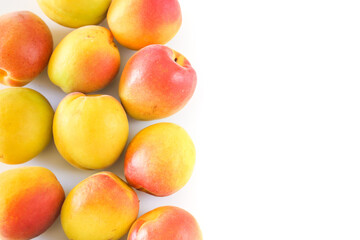 Yellow and red apricot fruit on white background, food concept, copy space, top view.
