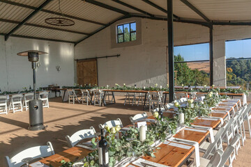 Inside Farm Barn Decor for Wedding Party Reception Dinner Tables Cutlery Settings indoors