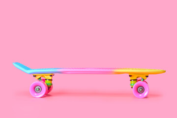 Pastel neon rainbow colored Penny board skateboard isolated on solid soft pink background. Plastic mini cruiser. Youth minimalistic Sport inspired summer fun concept. Copy space. - obrazy, fototapety, plakaty