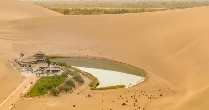 time lapse of the crescent spring, desert landscape at dusk, dunhuang city, gansu province, a famous tourist attraction in China.