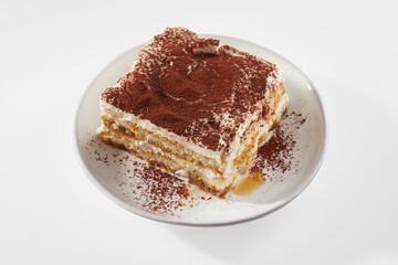 Piece of Tiramisu cake on table
