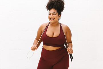 Fototapeta na wymiar Body positive woman with skipping rope