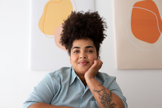 Woman sitting at desk and looking at camera