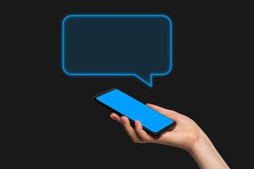 Phone message, chat. A woman's hand holding the phone in her hand on a dark background, the chat window is added as a graphic element.