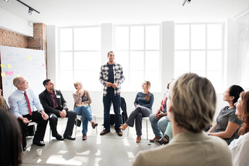 Fototapeta premium Guy standing and speaking in a circle