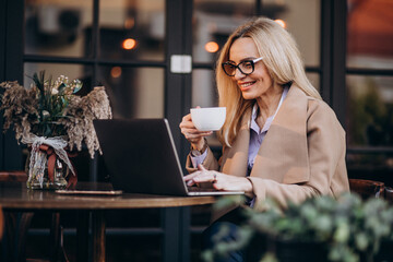 Elderly business woman shopping online using computer
