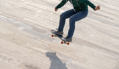 Asian woman skateboarder skateboarding in modern city