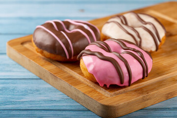 Delicious assorted colorful donuts on the table.