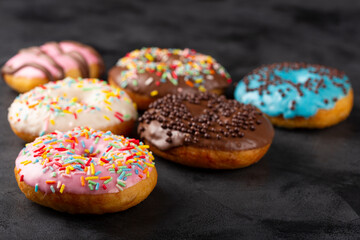 Delicious assorted colorful donuts on the table.