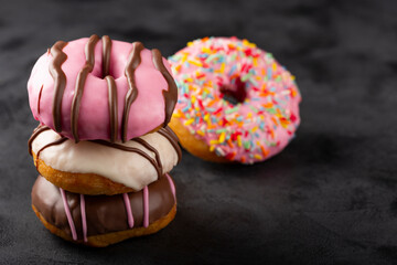 Delicious assorted colorful donuts on the table.