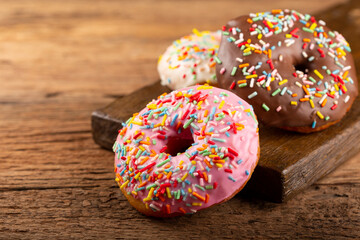 Delicious assorted colorful donuts on the table.