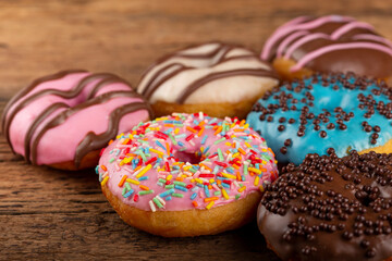 Delicious assorted colorful donuts on the table.