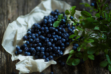 Fresh blueberries on a wooden background. top view, the berry is useful for improving vision....