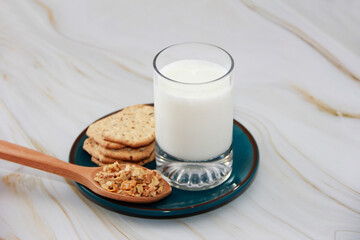 kefir in a glass and muesli in a spoon for a diet