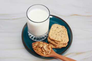 kefir in a glass and muesli in a spoon for a diet
