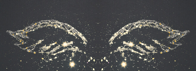 Abstract wings with gold glitter on black background 