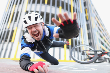 Cyclist screaming falls off bike onto asphalt