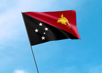 Papua New Guinea flag flying high in the sky Papua New Guinea independence day. World national flag collection