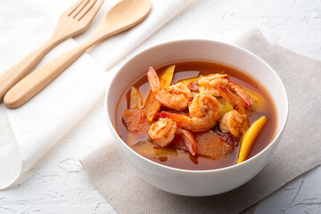 Sour Soup with Papaya and Shrimp in white bowl.Thai food