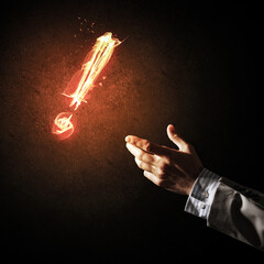 Concept of attention or punctuation with burning exclamation mark on dark background