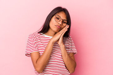 Young latin woman isolated on pink background yawning showing a tired gesture covering mouth with hand.