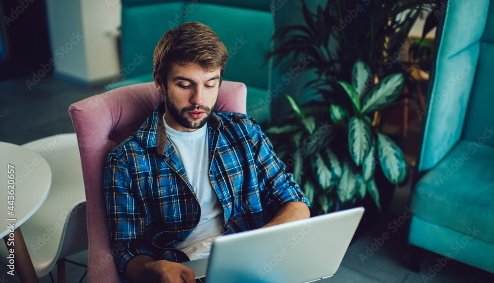 Poster skilled male it professional creating program code while doing distance job in coworking space, cauc
