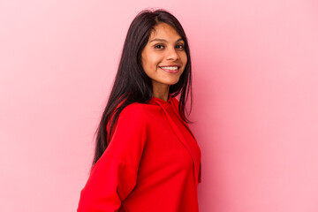 Fototapeta premium Young latin woman isolated on pink background confident keeping hands on hips.