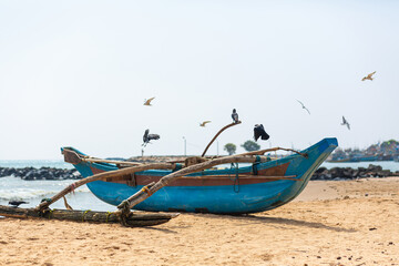 Fototapeta premium Wooden fishing boat on the ocean. Fishing village on the island