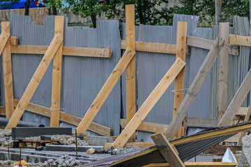 A fragment of a fence enclosing a construction site