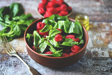 Healthy summer raspberry salad with basil in a bowl. Vegan food. Fitness lunch.