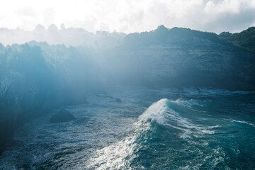 ocean water and wave near the rocky shore