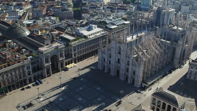 Aerial drone footage view of sunrise of famous statue on cathedral Duomo in Milan Italy  // no video editing
