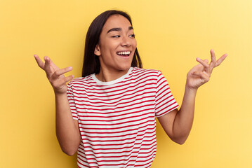 Young mixed race woman isolated on yellow background joyful laughing a lot. Happiness concept.