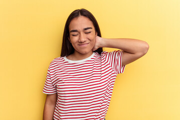 Obraz premium Young mixed race woman isolated on yellow background having a neck pain due to stress, massaging and touching it with hand.