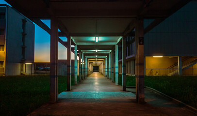 Hallway with geometric columns and diminishing perspective with Sunrise in the background, University Toulouse III