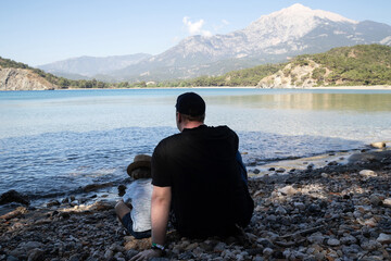 Father and son on a background of beautiful mountains and the Mediterranean sea
