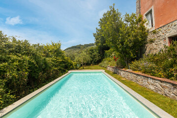 Exterior of Italian villa in Tuscany with swimming pool.