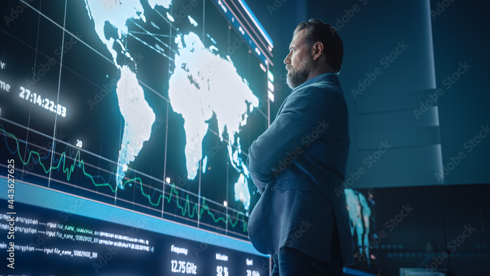 Poster Senior Computer Science Engineer Looking at Big Screen Display Showing Global Map with Data Points. Telecommunications Technology Company System Control and Monitoring Room with Servers.