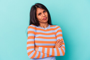 Fototapeta premium Young latin woman isolated on blue background unhappy looking in camera with sarcastic expression.