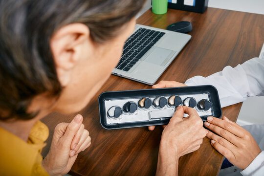 Selections of hearing aids at audiology center. BTE hearing aids to treat hearing loss, close-up