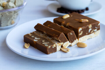 close-up cutting chocolate and milk sherbet with nuts on the white table. national traditional...