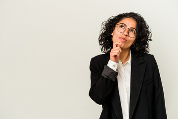 Young latin business woman isolated on white background looking sideways with doubtful and skeptical expression.