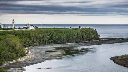 View on Cap-De-La-Madeleine lighthouse from the scenic route 132 in Gaspesie, Quebec (Canada)