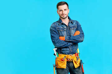 Portrait of confident handsome male construction worker with crossed arms and copy space