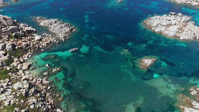 Aerial view of transparent, clean and blue mediterranean sea in a sunny summer day. Mediterranean sea landscape, turquoise, blue water, white rocks creating little islands, green vegetation 