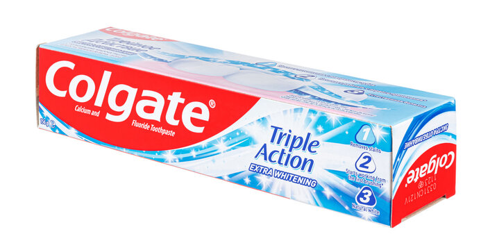 Moscow, Russia - March 27, 2021: Colgate Triple Action Extra Whitening toothpaste cardboard packaging with english inscriptions on front side isolated on white background