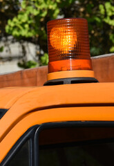 Orange colored light on the top of a vehicle