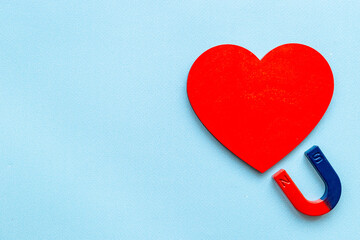 Horseshoe magnet attractives heart shapes. Love and relashionship concept