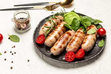 Homemade Pork Sausages with spinach, avocado and cherry tomato. Keto paleo diet menu. top view